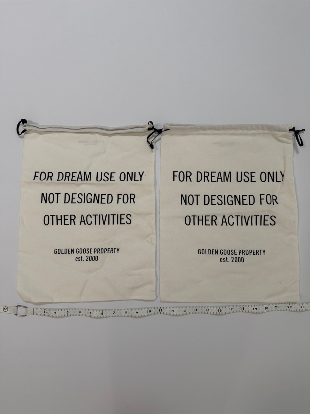 Golden Goose Cream Canvas Drawstring Bags with Black Text (Pair)